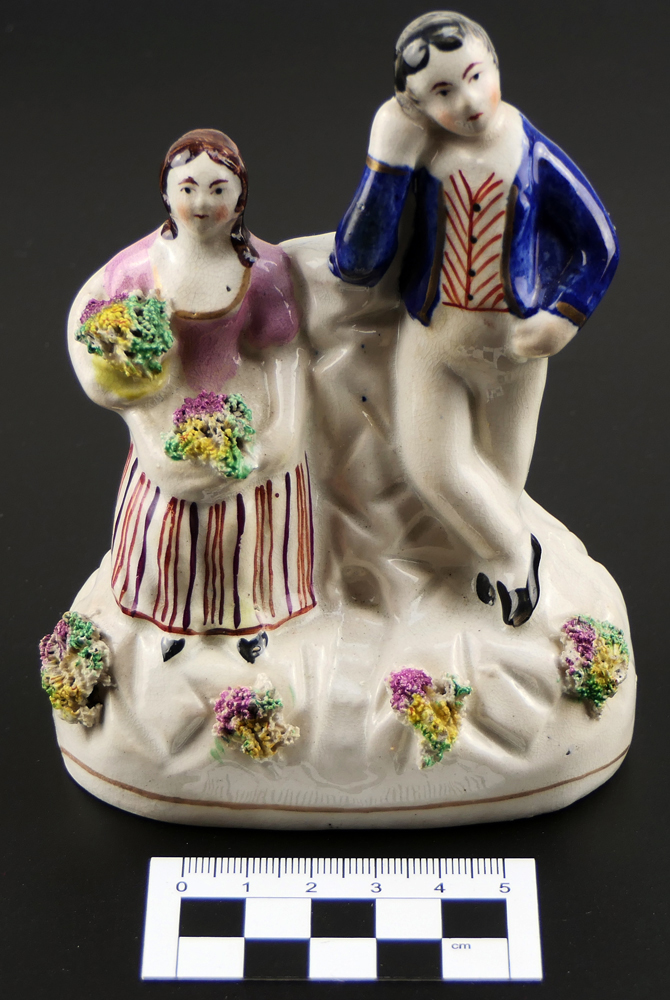 Ceramic figurine of boy and girl on mantelpiece, identical to that depicted in Collinson's painting