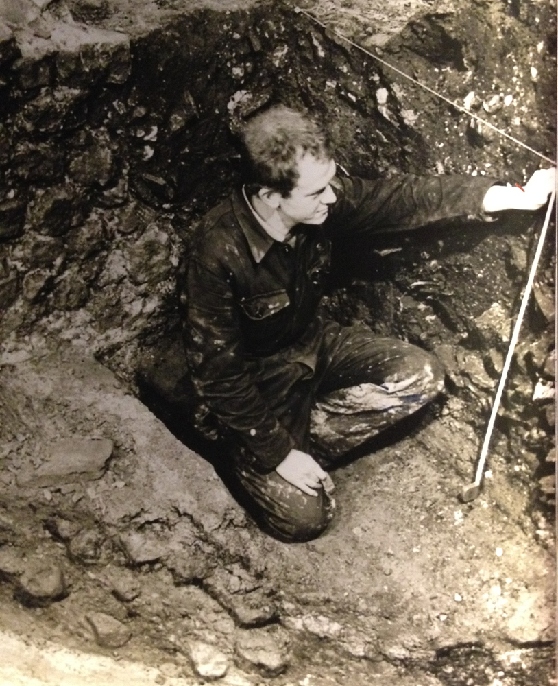 ralph mills in an archaeological trench, holding a tape measure
